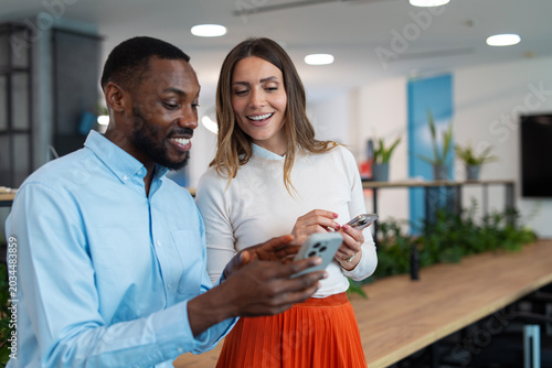 Business colleagues collaborating and communicating using smartphone technology