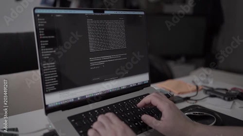 Man using artificial intelligence chat assistant on laptop while working at home office. Concept of automation, digital productivity and modern technology.
