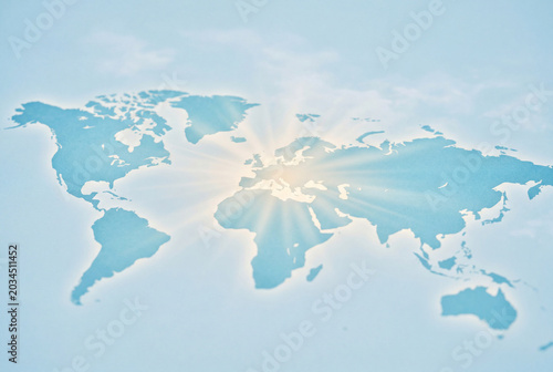 Conceptual world map with sun rays from Europe and Africa in blue