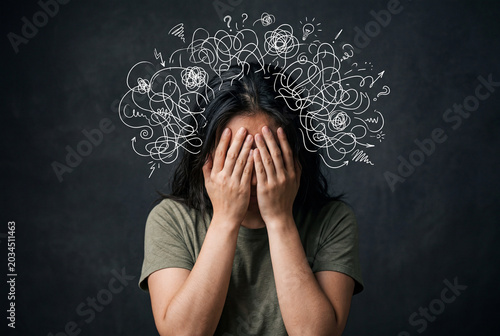 Asian woman covering face with chaotic thought lines for stress