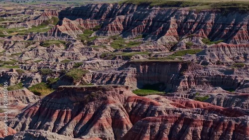 Aerial view of dramatic eroded colorful rock formations and badlands terrain near Badlands National Park, South Dakota
