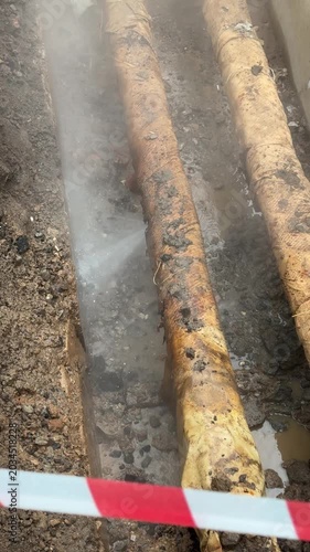 Old worn heating pipelines in underground trench requiring replacement due corrosion damage and infrastructure aging