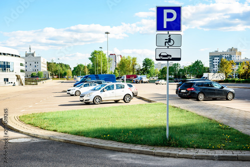 Cars parked in a city public parking lot.