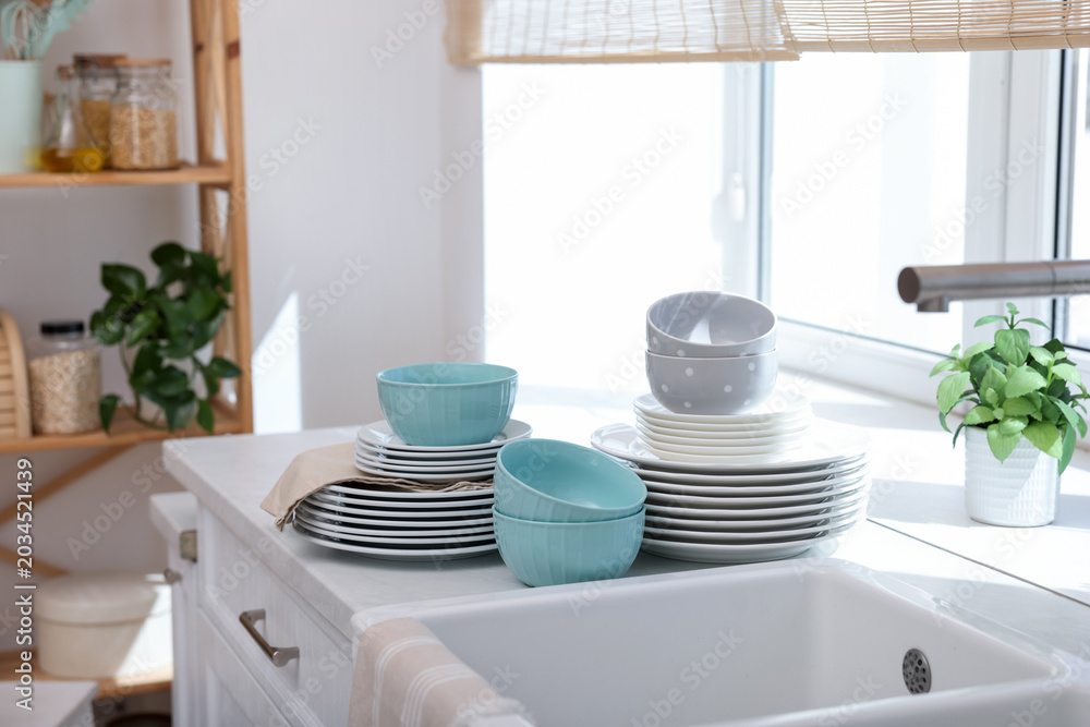 Fototapeta premium Set of clean dishes on countertop in kitchen