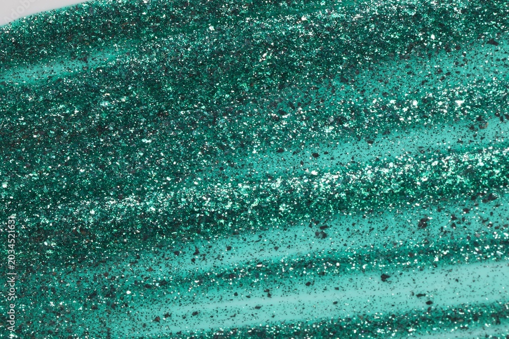 Obraz premium Green glitter nail polish as background, top view