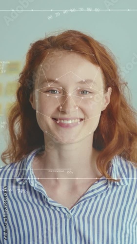 Woman with red hair undergoes identity check using biometric facial overlay in workplace environment