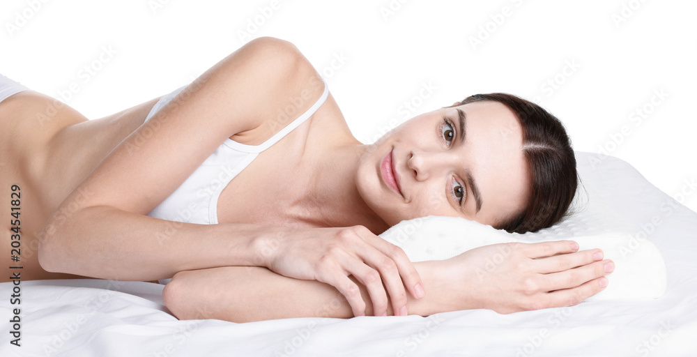 Obraz premium Woman lying on bed with orthopedic pillow against white background