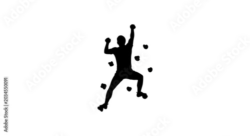 Silhouette of a person rock climbing on a climbing wall with holds