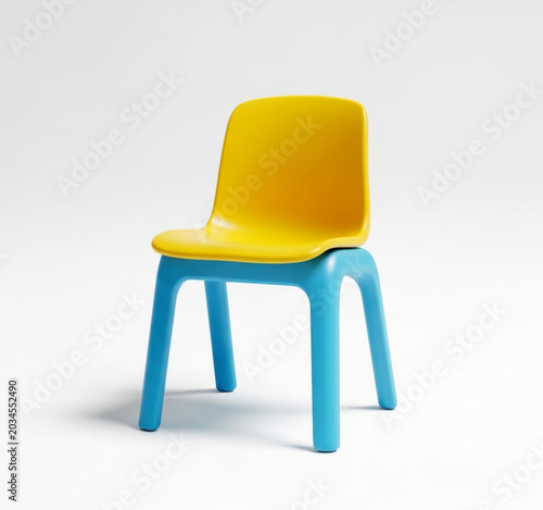 Simple small blue plastic kid chair isolated on white background for children playroom and kindergarten furniture
