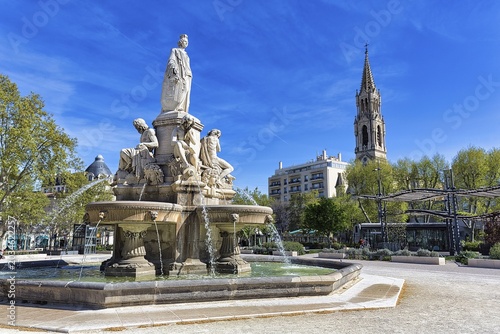 Fontaine Pradier, large fountain in the square Esplanade Charles-de-Gaulle, bell tower of the church Sainte-Perpétue and Sainte-Félicité, Nîmes, Languedoc-Roussillon, France