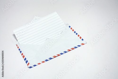 Canvas-taulu An open airmail envelope with a blank piece of lined paper inside, isolated on a