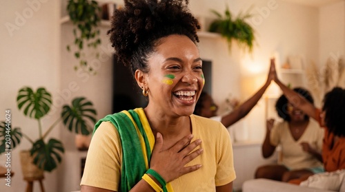 Happy Group of Black Female Friends Laughing and Cheering Together in a Cozy Living Room