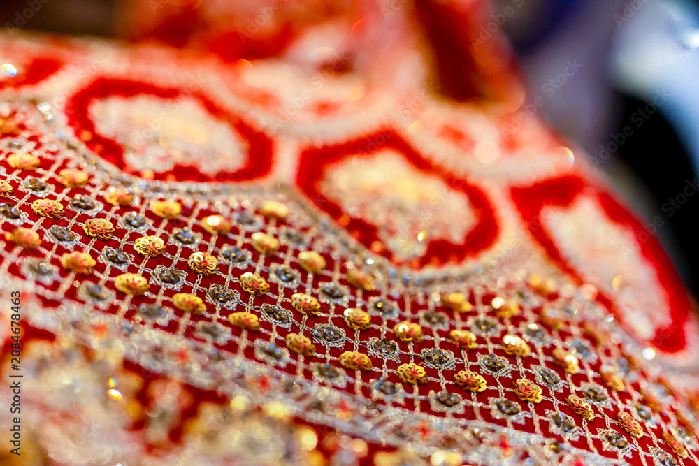 Fototapeta premium Indian bride's traditional outfit fabric and texture close up