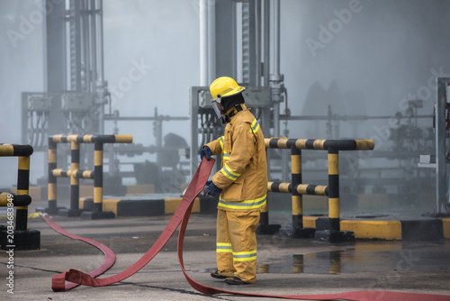 Bild auf Leinwand Firefighters practiced responding to fires in buildings and oil depots using water and foam