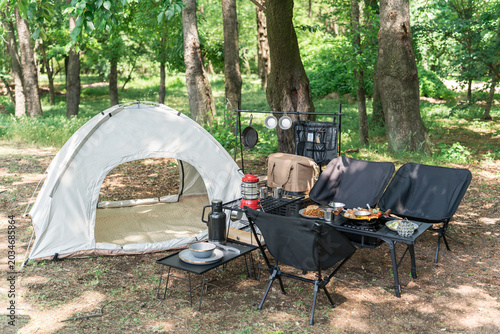Camping equipment set up in a campground or park, campsite, day camp