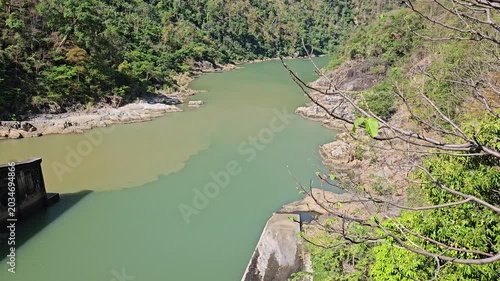 The emerald river flowing through a rocky canyon at Ialy Hydroelectric Power Plant in Gia Lai, Vietnam.