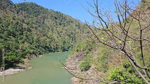 The emerald river flowing through a rocky canyon at Ialy Hydroelectric Power Plant in Gia Lai, Vietnam.
