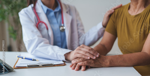 Bild auf Leinwand Doctor comforting senior patient offering empathy and support
