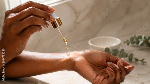 Luxurious skincare ritual involves applying nourishing oil to enhance skin radiance and hydration while promoting self care and relaxation