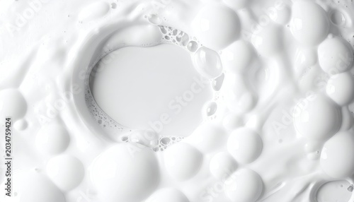 Close-up of churning white liquid forming frothy bubbles and a central vortex