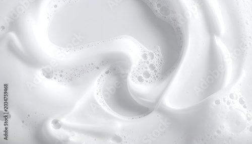 Swirling close-up view of foamy, white liquid with varying textures and air bubbles