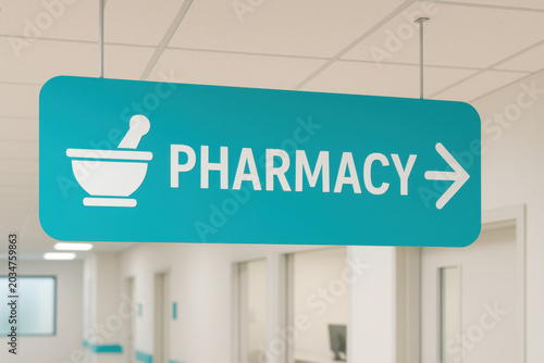 Teal pharmacy directional sign hanging from ceiling with mortar pestle symbol and arrow pointing to medical service area in healthcare facility