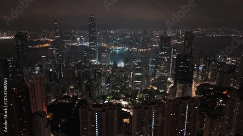 Cinematic drone footage of glowing Hong Kong cityscape after dark