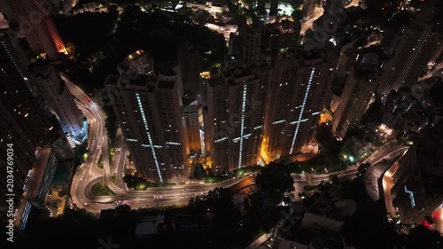 Drone night view of Hong Kong skyscrapers and winding roads