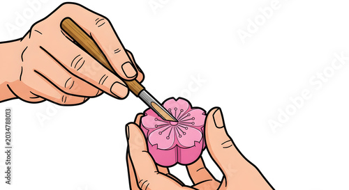 Artisan hands decorating a pink cherry blossom wagashi sweet