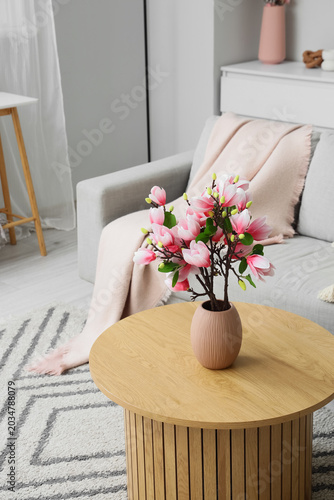 Vase with artificial magnol...