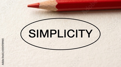 Handwritten simplicity concept on crumpled paper with red pencil minimal design
