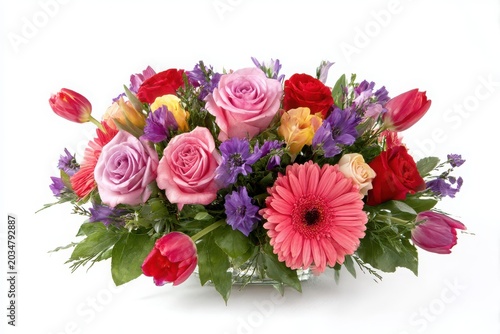 Vibrant assortment of fresh roses tulips gerbera daisies and mixed flowers in a lush arrangement white background