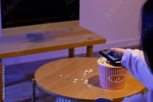 Woman with tasty popcorn wa...