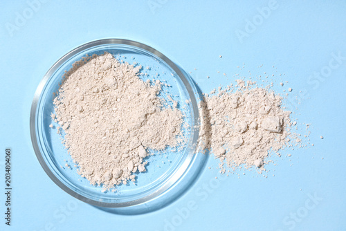 Petri dish with powder on b...