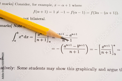 Pencil on mathematic formula exercise test paper in education school.