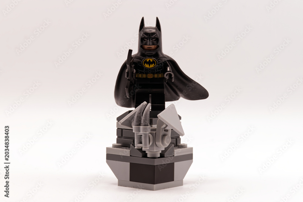 Obraz premium Bologna - Italy - April 2026: A batman lego minifigure standing on a grey brick pedestal against a white background.