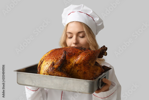 Young female chef with tast...