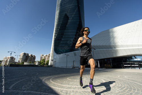 Man running in vibrant urban setting on a sunny day