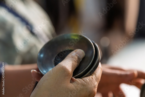 Konstfotografi hands holding metal plates traditional musical instruments close up