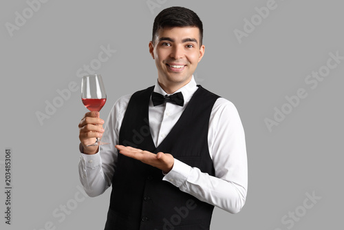 Young sommelier with glass ...