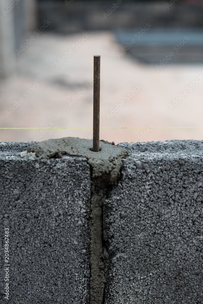 Fototapeta premium Concrete block wall surface with mortar joints for construction work.