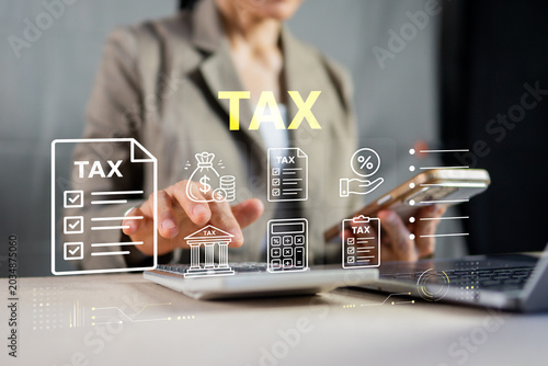 Fotografie Businesswoman using calculator and smartphone for tax return filing and financia