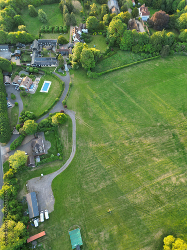 High Angle View of British Countryside and Landscape of Bedfordshire England UK. Drone Camera Footage Was Captured Medium High Altitude During Bright Sunny Day With Blue Sky and Hot Summer Day Over UK