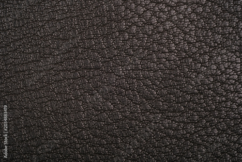 Dark leather fabric texture close up