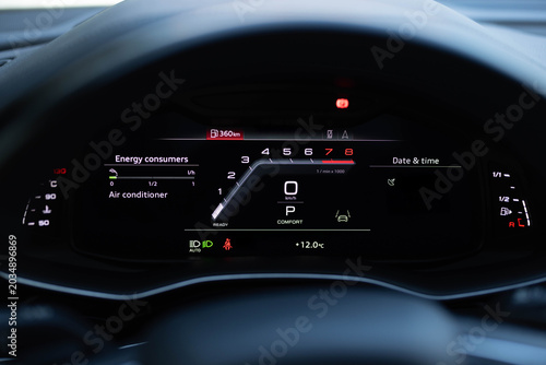 Many different car dashboard lights illuminated. Petrol meter on black background. Hybrid car digital display panel. Starting car engine. Tachometer Gauge of Starting and Stopping Car