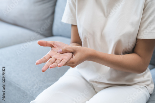 Bild auf Leinwand Health care and medical concept, rheumatism asian woman hand pain from cramp, trigger finger, wrist pain touching massaging, hand holding ache joint, arthritis inflammation