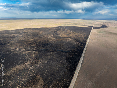 Darkened earth marks a burned landscape
