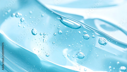 Close up of transparent light blue cosmetic gel serum background.