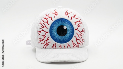 White baseball cap with a blue eyeball embroidery isolated on white background