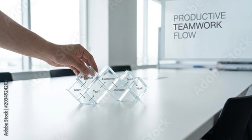 A person placing a piece of glass on a table representing productive teamwork flow and collaborative efforts